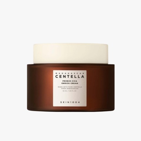 Brown cosmetic jar with a white lid labeled Centella Probio-Cica Enrich Cream on a light background