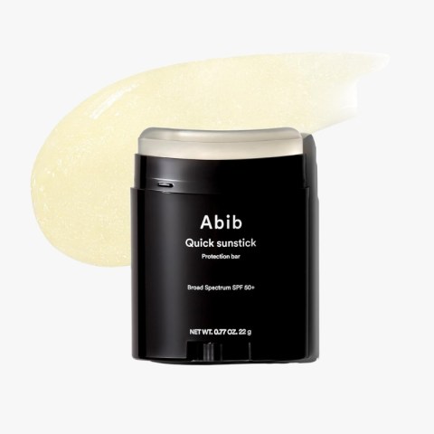 Abib Quick Sunstick sunscreen in a black container with a beige swatch behind, highlighting SPF 50+.