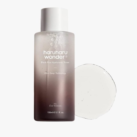 Haruharu Wonder Black Rice Hyaluronic Toner bottle with white cap beside a round cotton pad (150 ml)