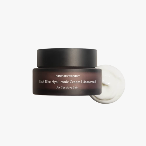 Brown jar of Haruharu Wonder Black Rice Hyaluronic Cream Unscented for Sensitive Skin, with a dollop of cream beside it.
