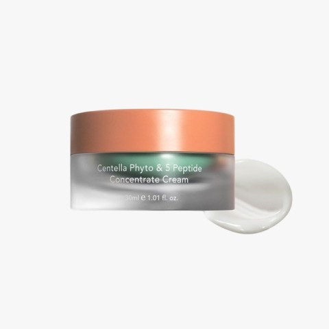 Jar of Centella Phyto & 5 Peptide Concentrate Cream with peach lid and a dollop of cream beside it