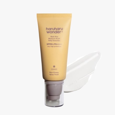 Haruharu Wonder Black Rice SPF50+ sunscreen tube with a white cream swirl behind it on a white background.
