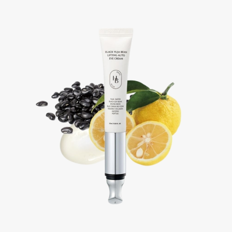 Tube of Black Yuja Bean Lifting Auto Eye Cream with black beans and lemon halves in the background.