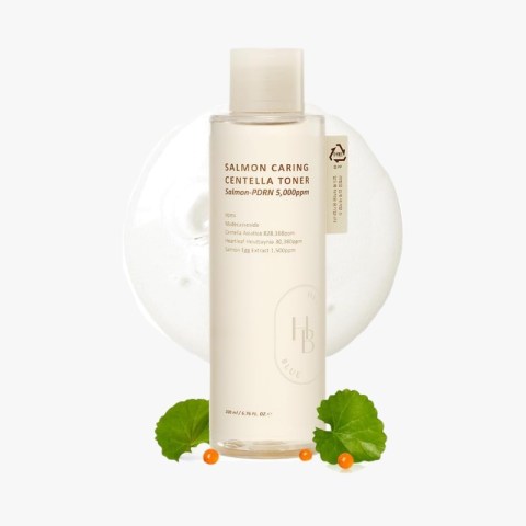 200 ml bottle of Salmon Caring Centella Toner on a white background with green leaves and orange berries for a fresh cosmetic presentation
