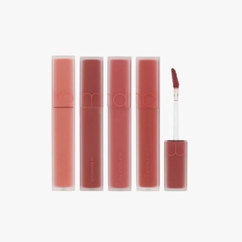Set of four lip tint tubes in nude to pink shades with an applicator wand on the right, showing the variety of colors.