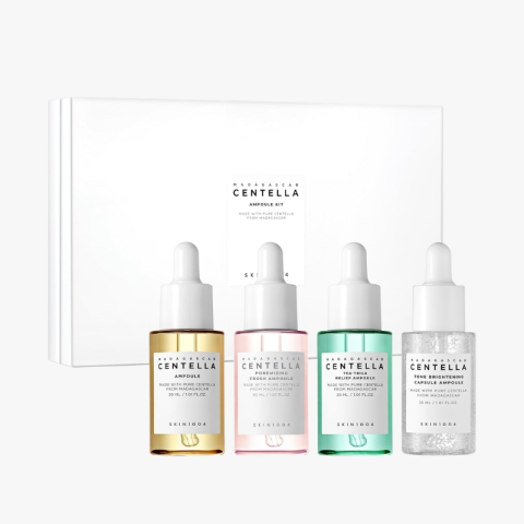 Four Centella ampoule bottles (amber, pink, teal, clear glitter) with droppers, in front of a white box.