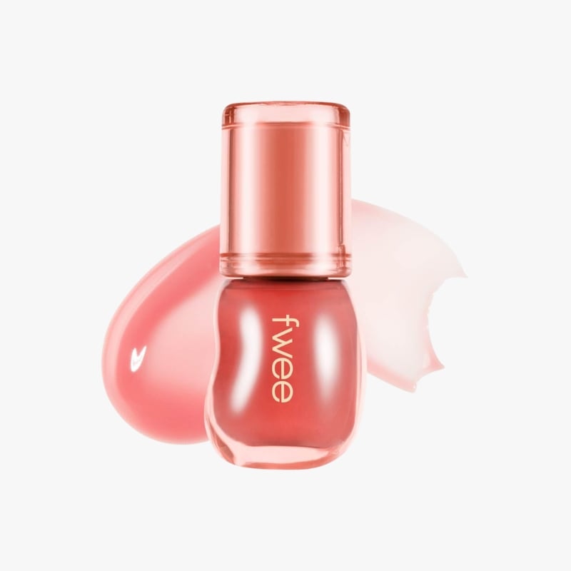 Pink nail polish bottle with a rose-tinted cap and a swatch of pink polish behind it.