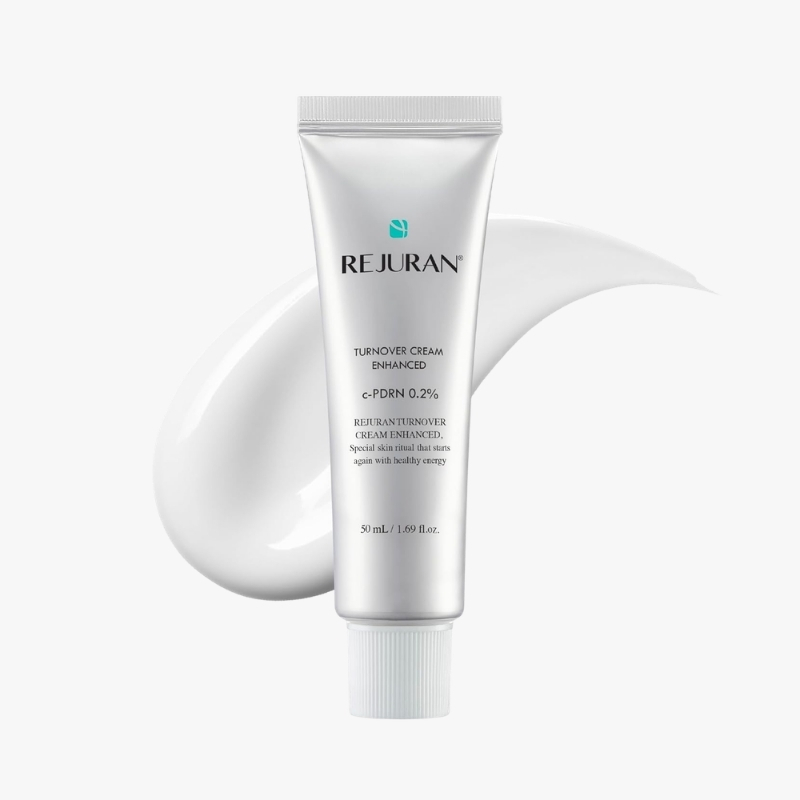 Silver REJURAN Turnover Cream Enhanced tube with a white cream smear in the background, cosmetics product image