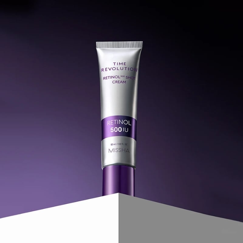 Tube of Missha Time Revolution Retinol 500 IU cream standing upright on a purple background.