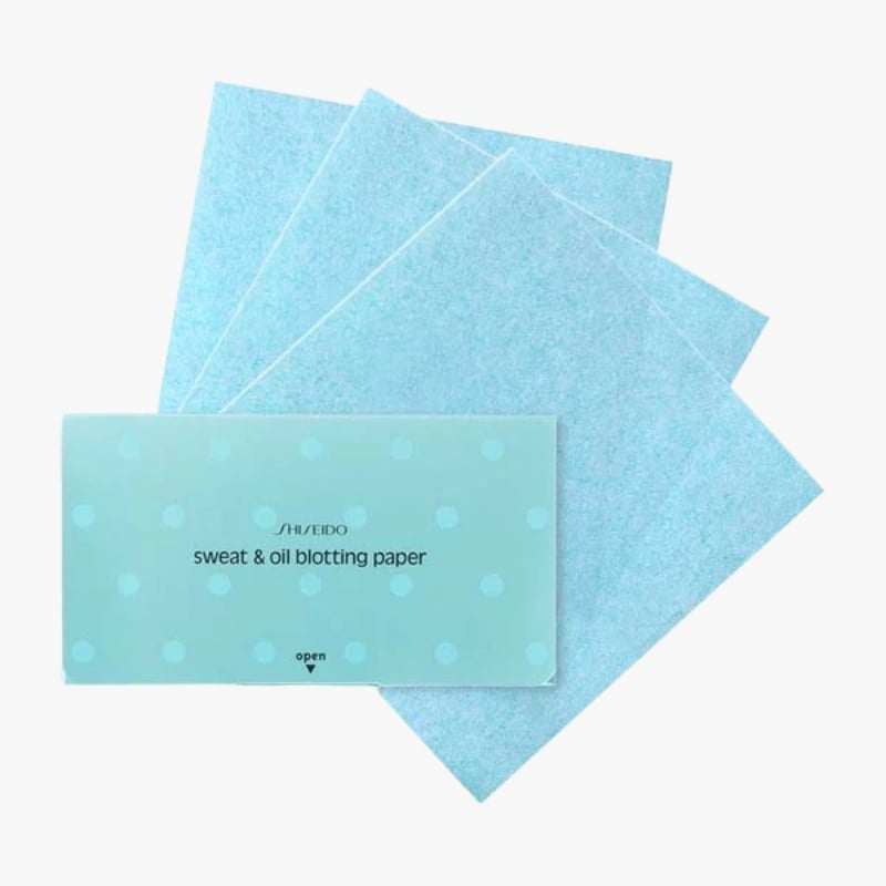 Light blue box labeled 'sweat & oil blotting paper' with four blue sheets behind it, fanned out.