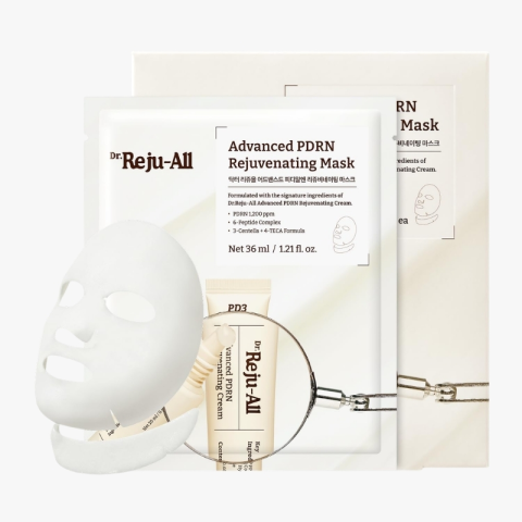 Packaging and sheet mask for Dr. Reju-All Advanced PDRN Rejuvenating Mask with a magnifying glass accessory in the foreground.