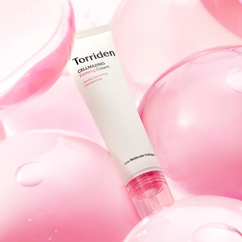 Tube of Torriden CELLMAZING Firming Cream surrounded by pink balloons, skincare product on a pink backdrop