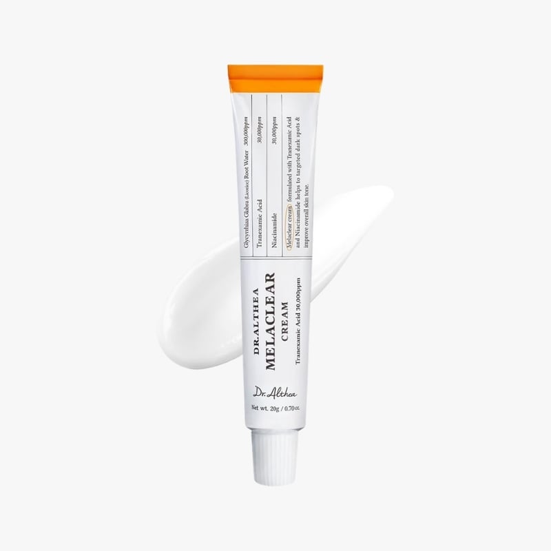 White cosmetic tube with an orange cap labeled Dr. Althea Melaclear Cream, shown with a smear of cream on a white background.