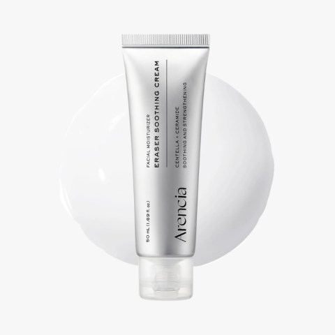 Silver tube of facial moisturizer labeled 'Eraser Soothing Cream' standing upright against a white background with a pale circle behind it.