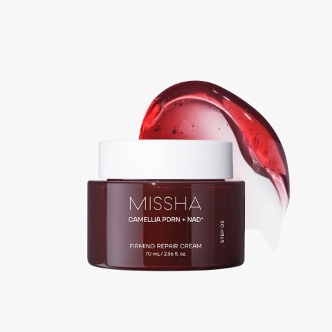 Missha Camellia PDRN + NAD firming repair cream jar with white lid and a red gel splash in the background