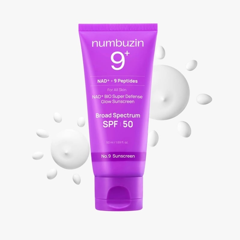 Purple numbuzin 9+ sunscreen tube with SPF 50, surrounded by white splash droplets.