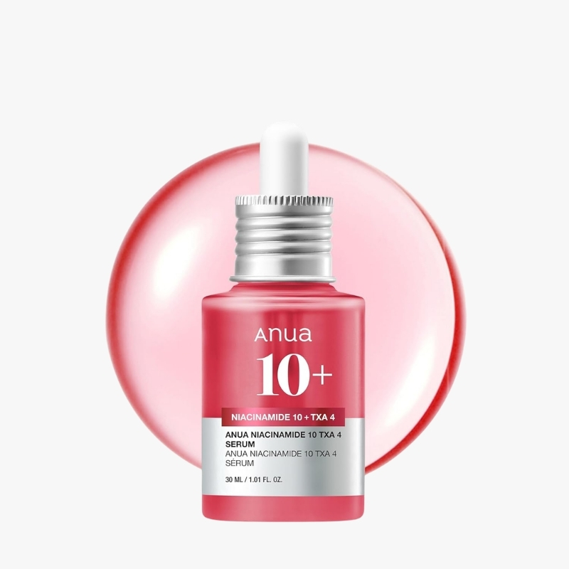 Red skincare serum bottle labeled 'anua 10+' with a dropper cap against a pink circular backdrop