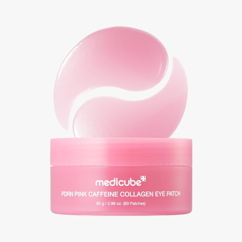 Pink jar labeled Medicube PDRN Pink Caffeine Collagen Eye Patch with a curved pink eye patch resting on top, ready for use in a skincare routine