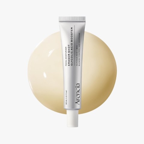 Silver skincare tube labeled 'facial moisturizer' standing upright in front of a pale beige circular backdrop